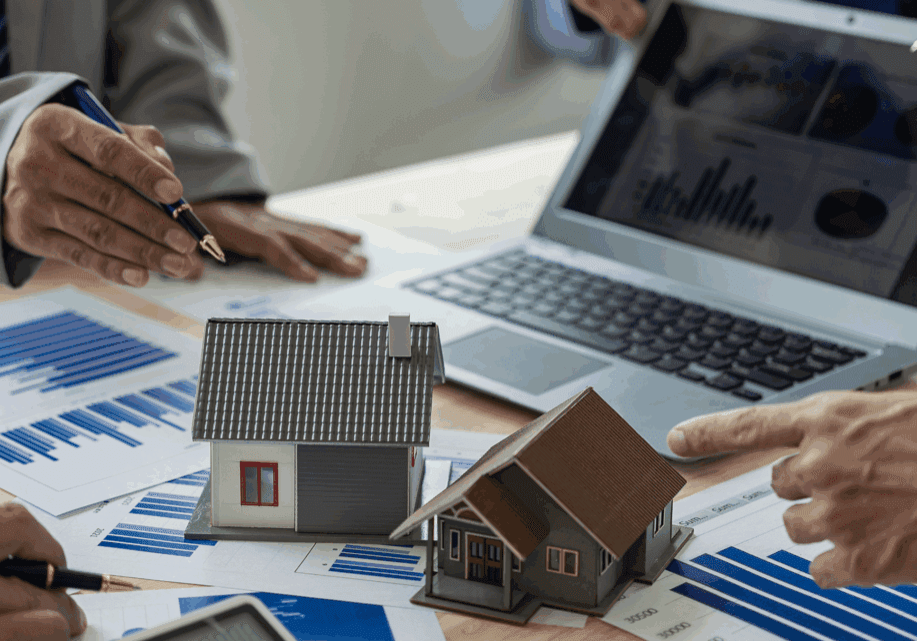 Real estate meeting with charts and models.